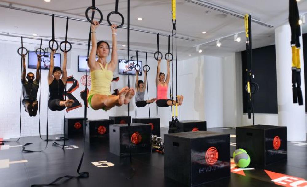 Fitness classes Singapore featuring functional suspension training workouts
