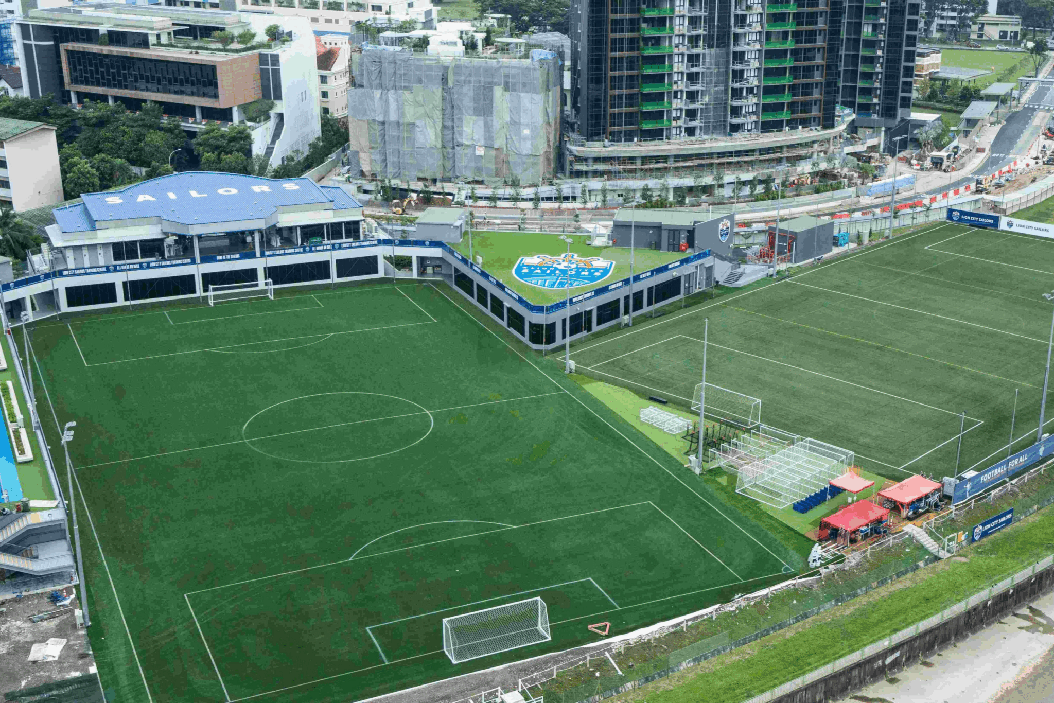 Modern football academy training field in Singapore with artificial turf and professional sports facilities.