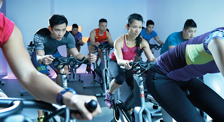 Fitness classes Singapore indoor cycling workout session
