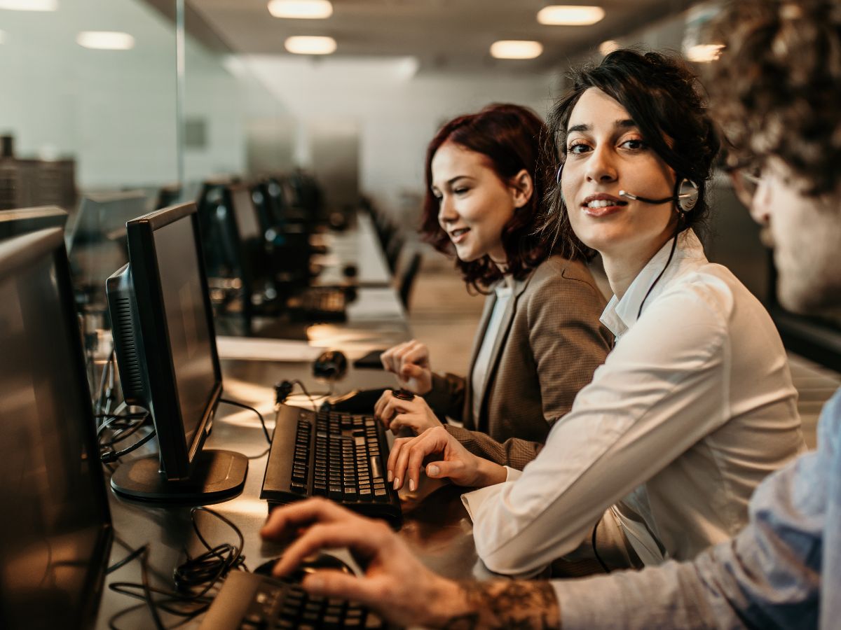 Managed IT support team working at computers in a modern office