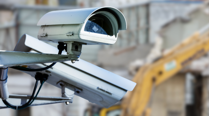 Close-up of modern CCTV surveillance camera monitoring a construction site