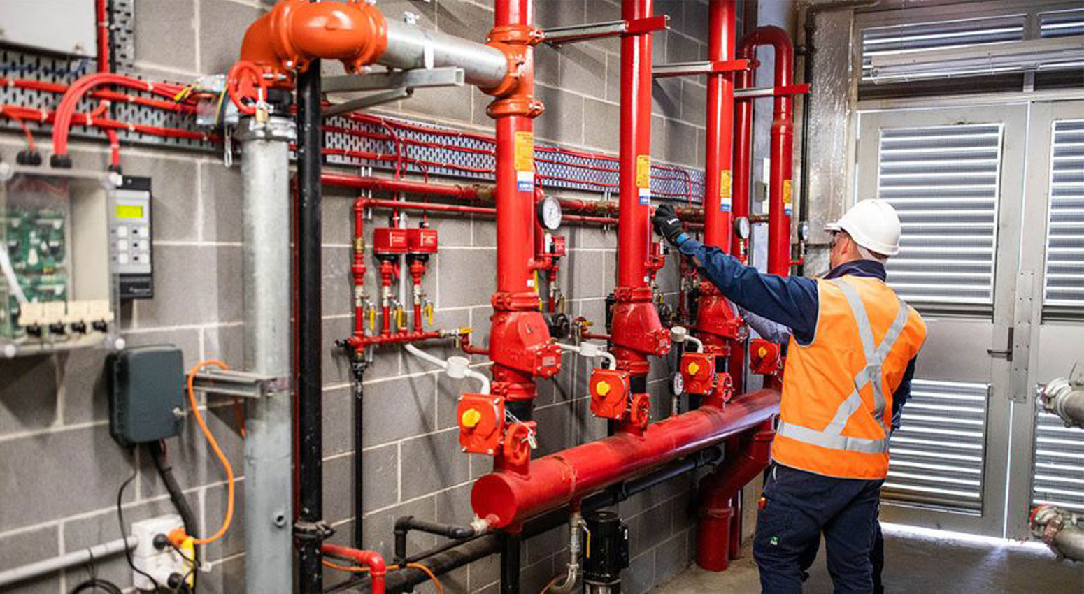 Engineer maintaining an automatic fire sprinkler system