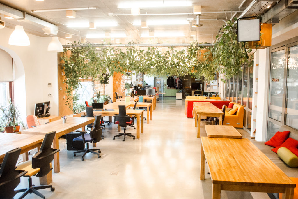Bright coworking workspace with hot desks and collaborative areas