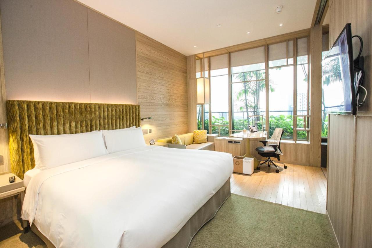 Luxury boutique hotel bedroom with large windows and natural light