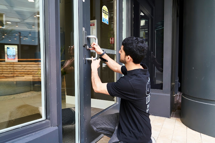 Best Locksmith Singapore Locksmith installing a new storefront door lock in Singapore